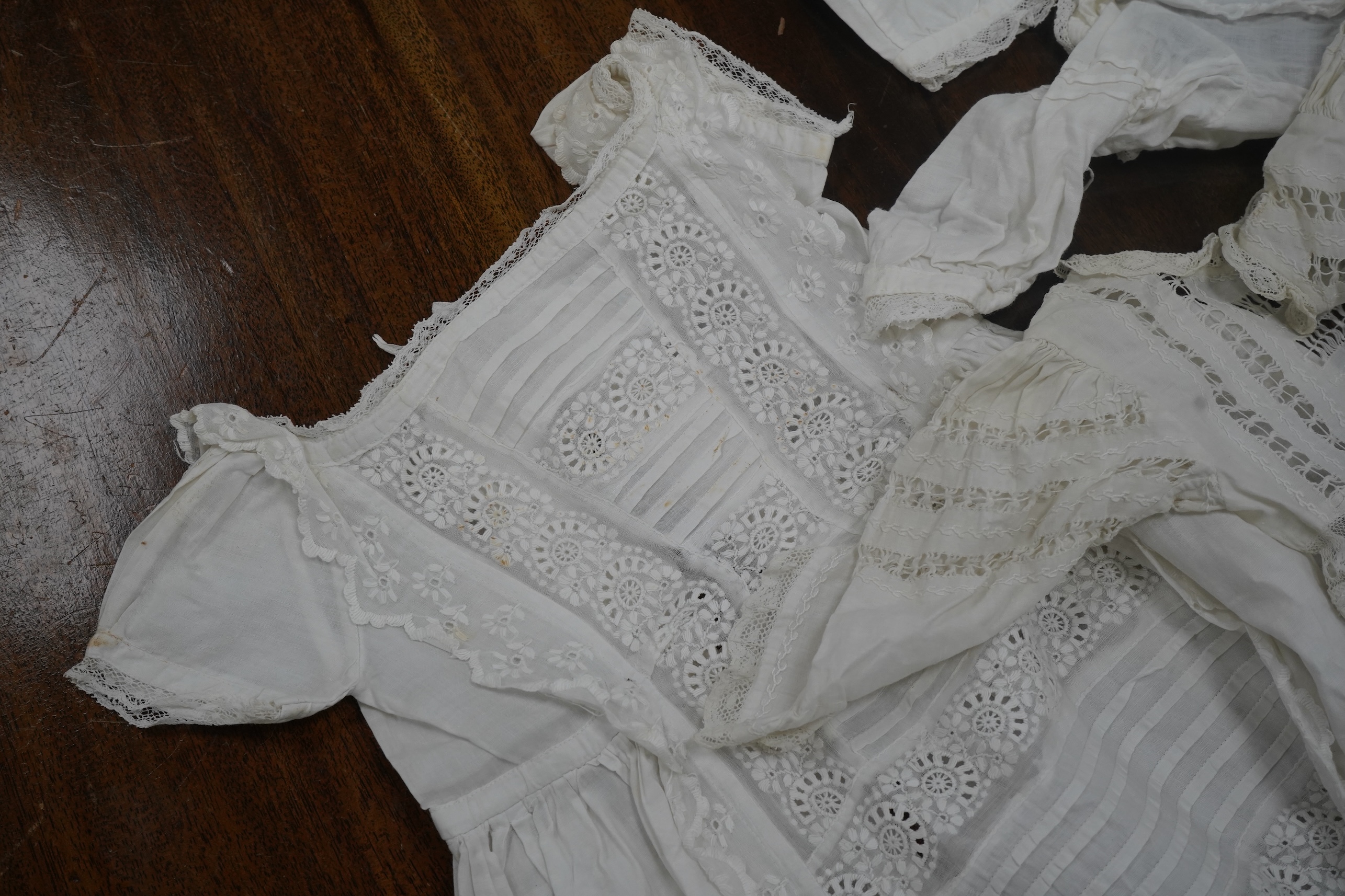 Five Victorian white worked fine cotton and lawn baby’s christening gowns. mostly worked with embroidery anglaise, feather stitching, tucking, drawn thread work and lace edging, longest 41cm. Condition - in good conditio